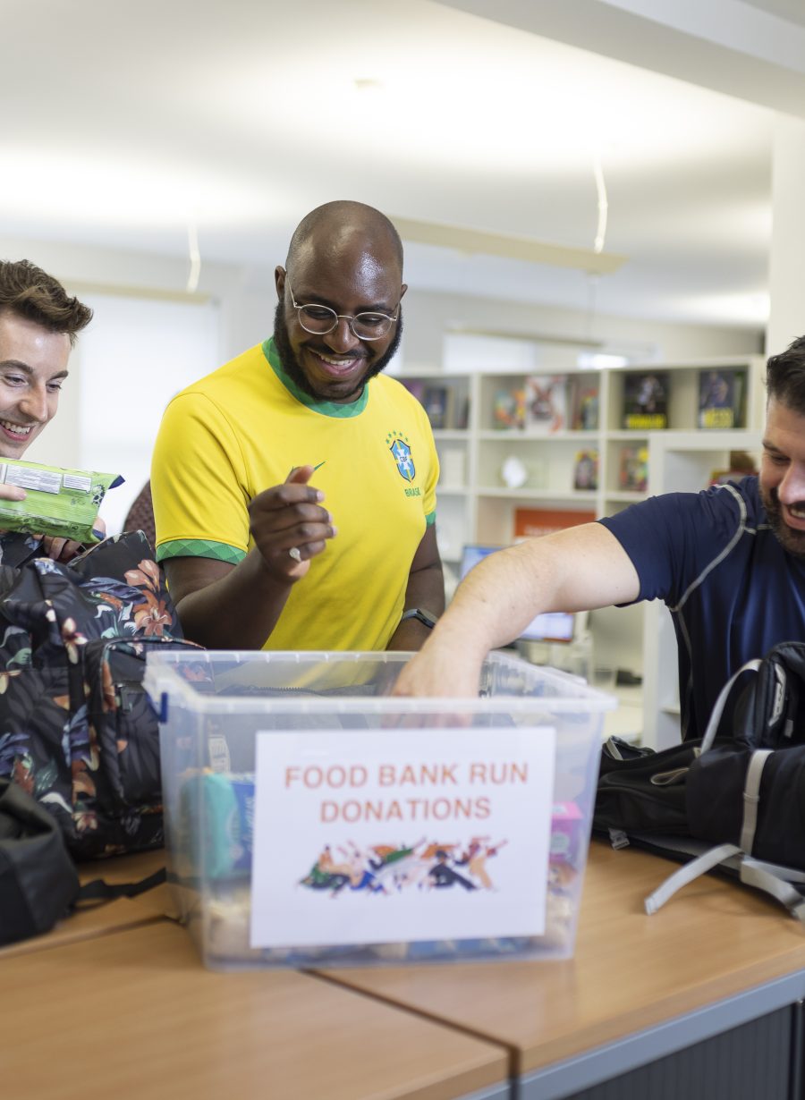 Think team putting food in a box for a food bank