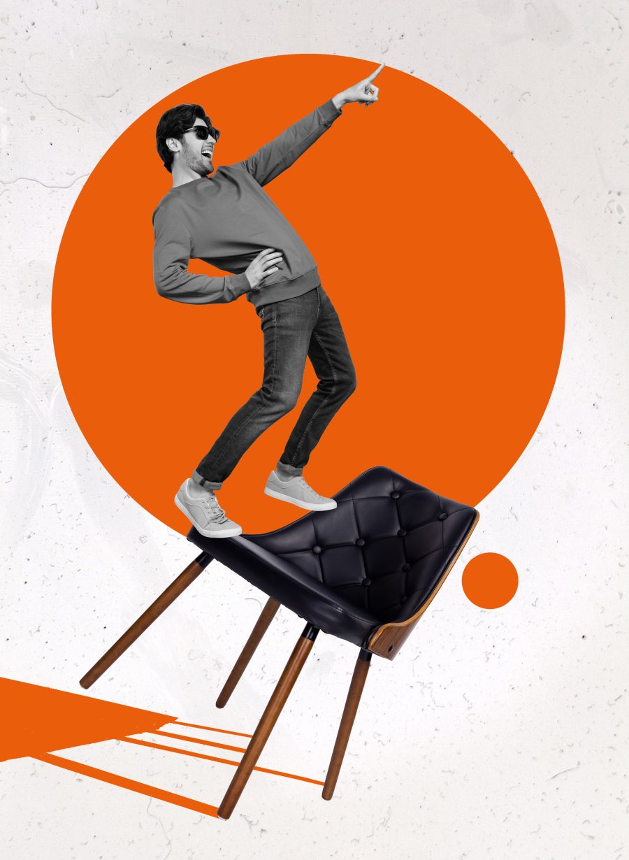 Man standing on a chair and pointing