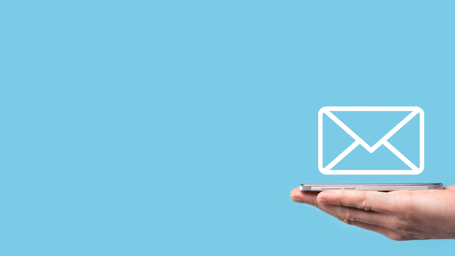 Mobile device on hand with email icon above