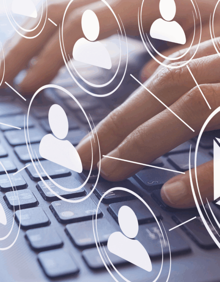 Image of person typing with email icon connecting to users